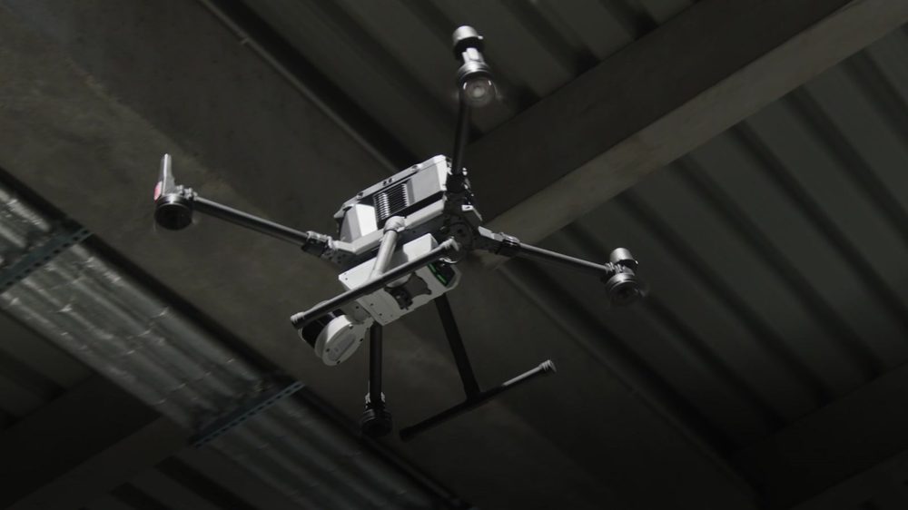 An Artec Jet mounted beneath a quadcopter drone flying under a concrete structure